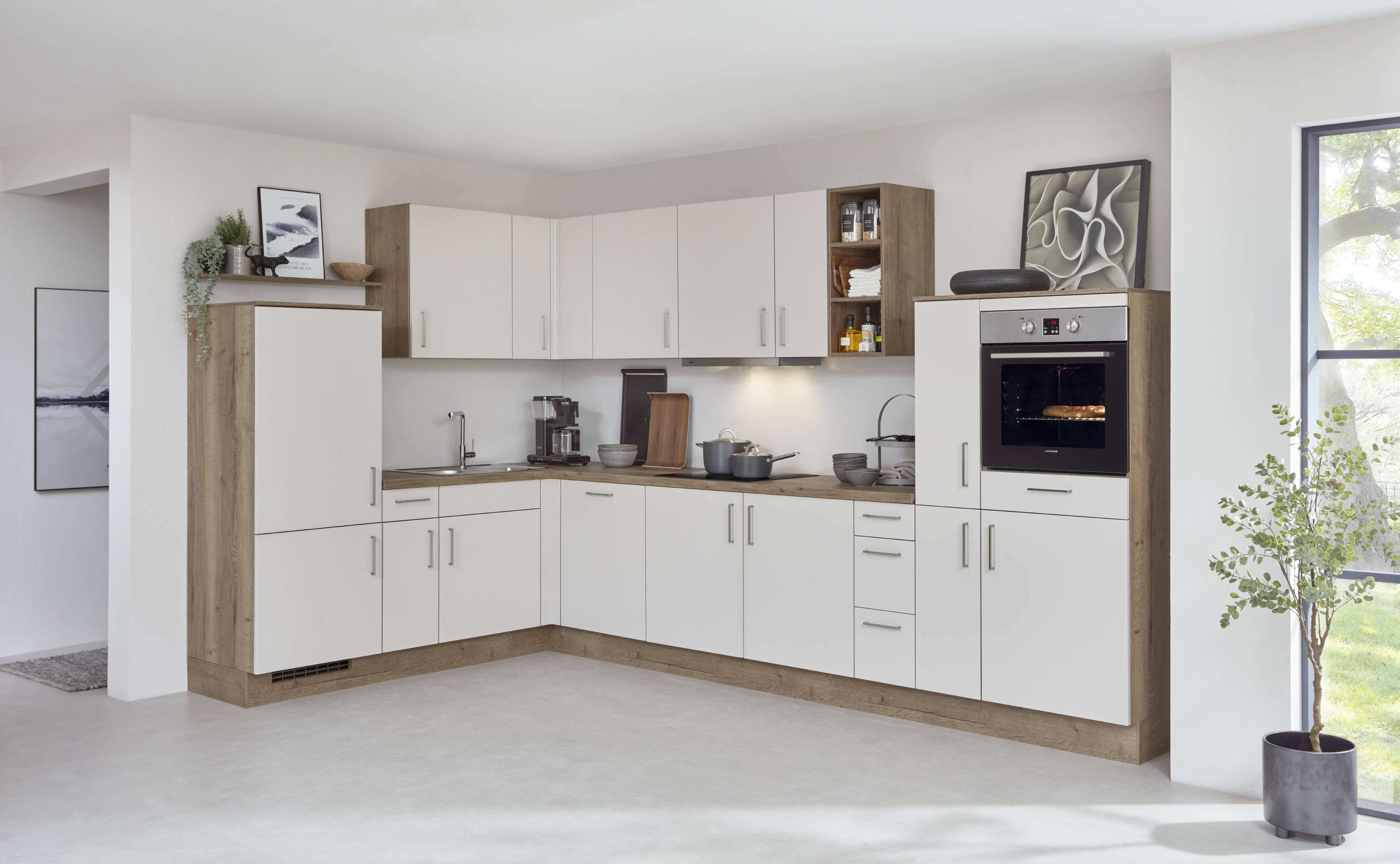 Small kitchens feel bigger when the layout is clean, storage is intentional, and the eye has room to rest.