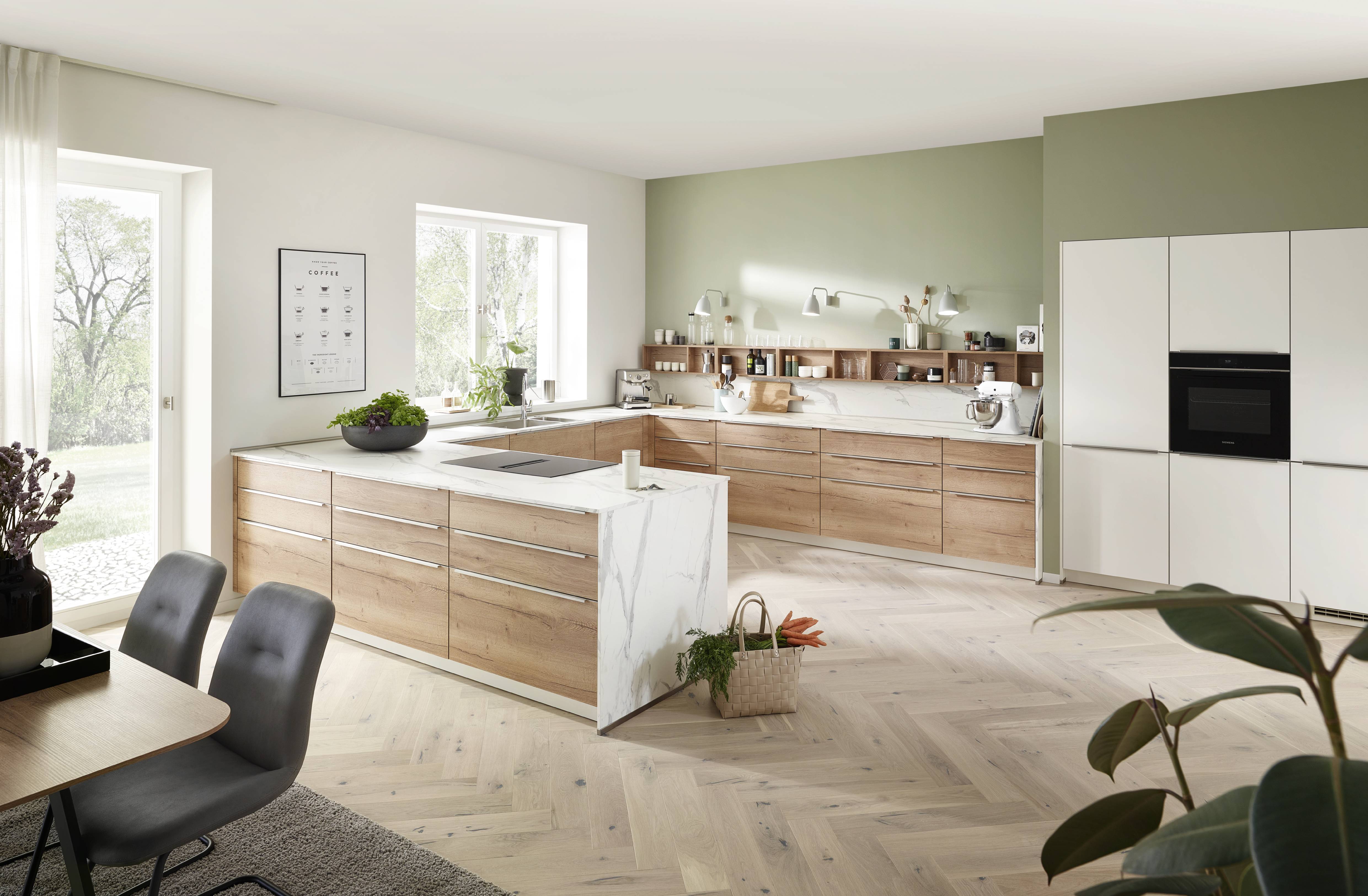 A warm, family-friendly kitchen layout with a generous island, wood cabinetry accents, and bright natural light.