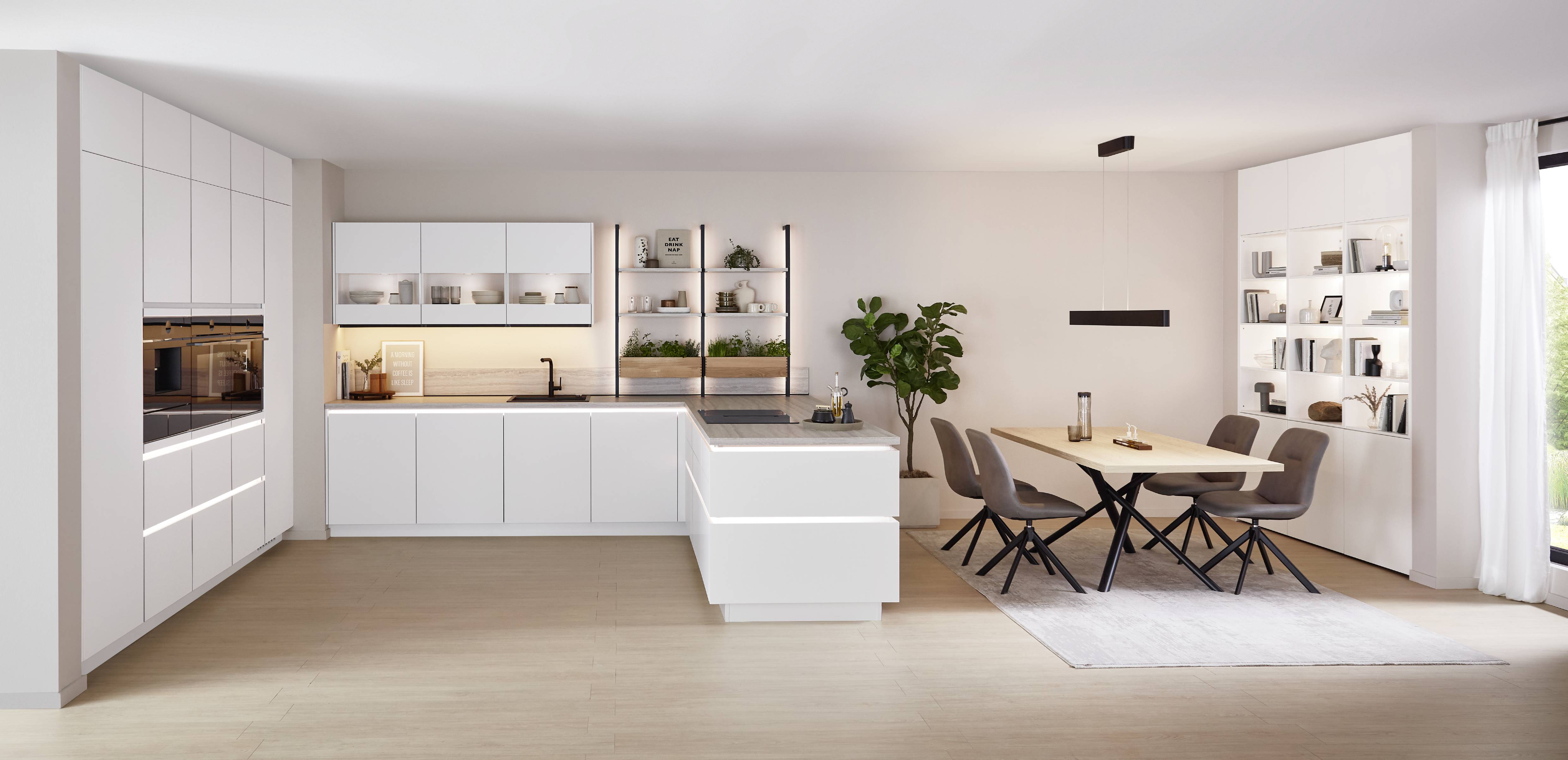 noblessa USA - Modern White Kitchen with Open Shelving and Island Bright modern white kitchen featuring sleek cabinetry, an island with an induction cooktop, open shelving with decorative dishes and plants, and an adjoining dining area with a wooden table.