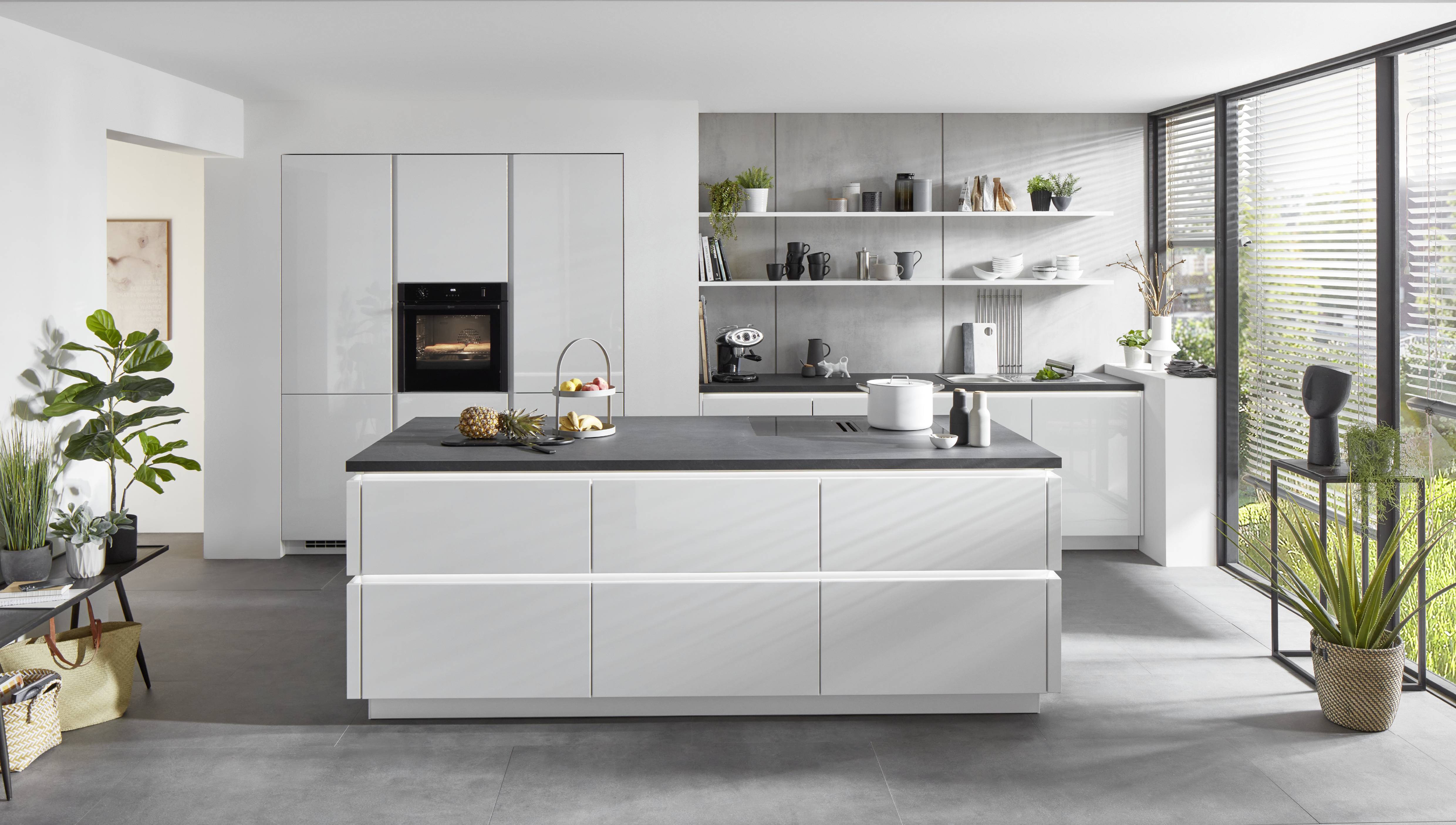 Bright modern kitchen with a dark stone-look island countertop and clean-lined cabinetry.