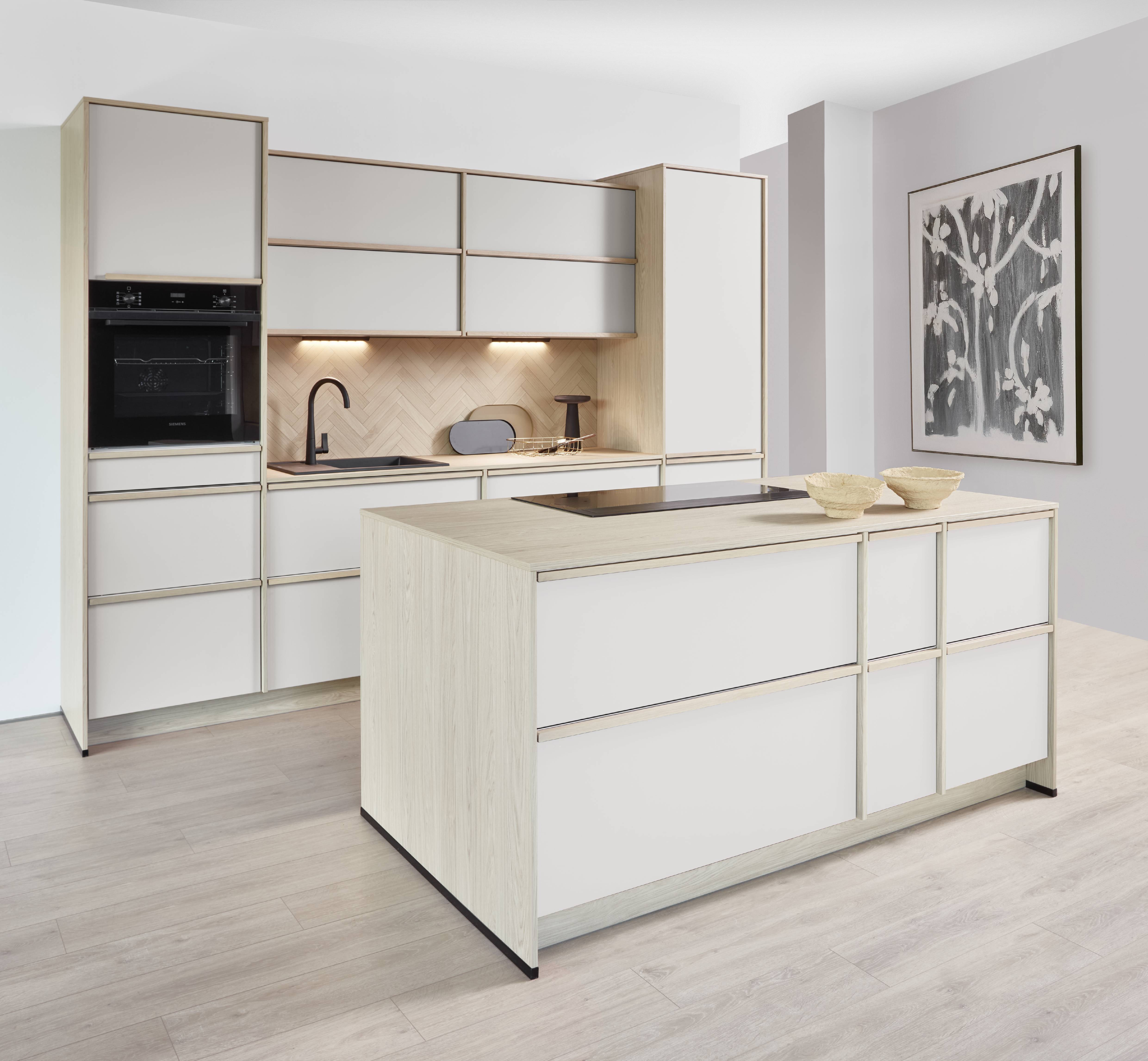 Light Wood and White Modern Kitchen with Storage-Forward Island Bright modern kitchen with light wood and white cabinetry, integrated appliances, herringbone backsplash, and a compact island designed for extra prep space and storage.