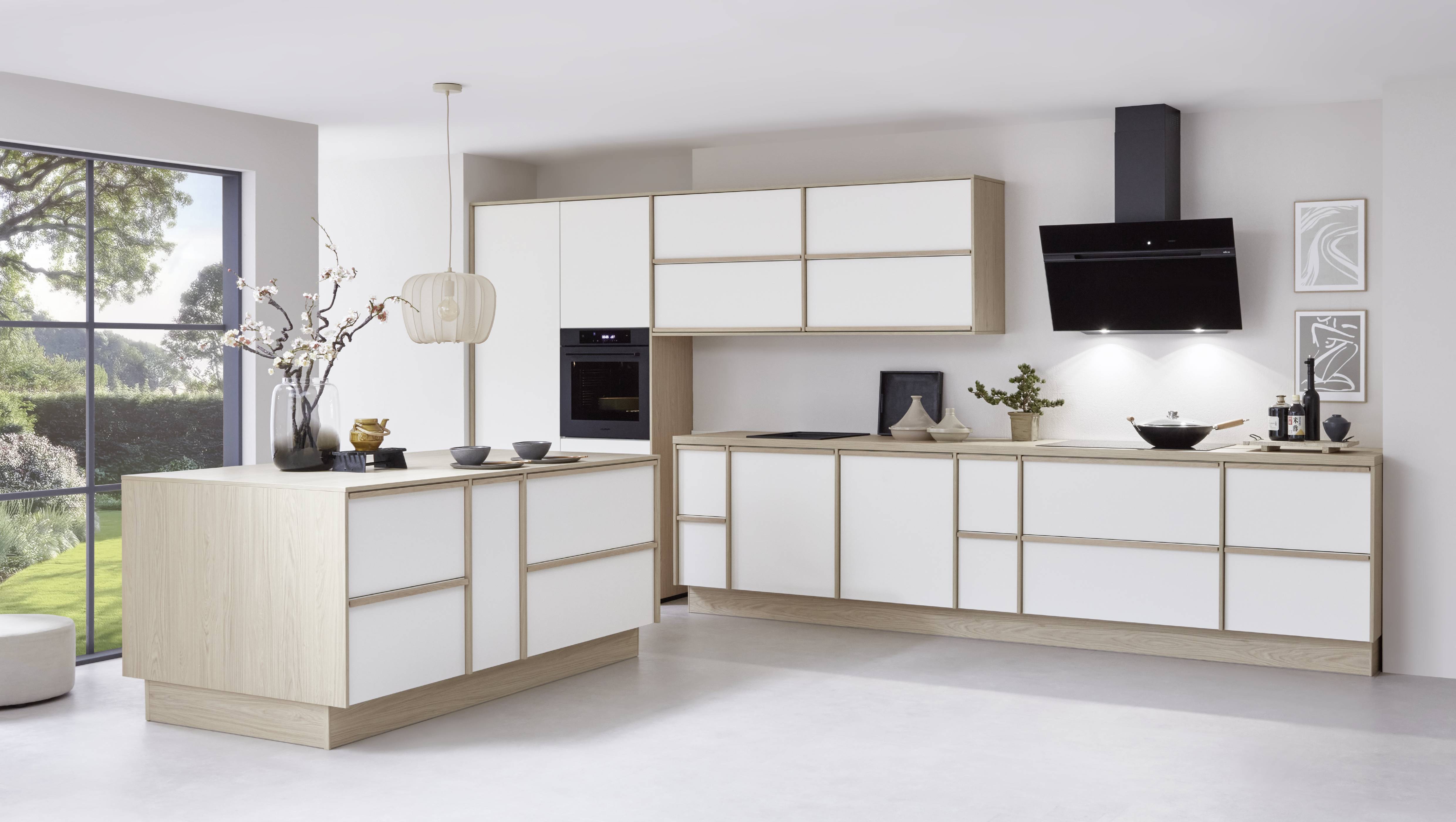 Two-tone kitchen with white cabinet fronts and light wood framing, plus a clean island layout in a bright space