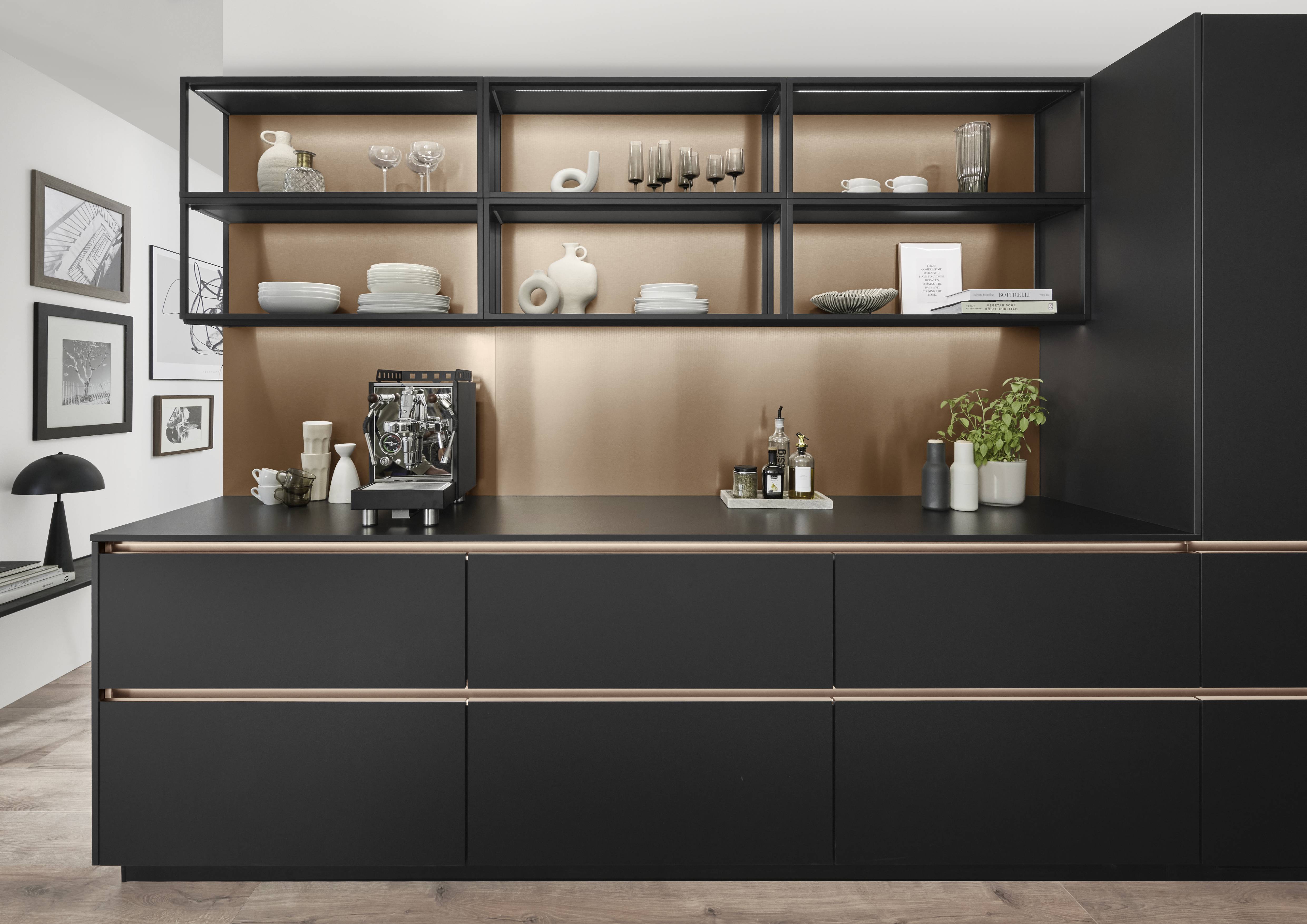 Matte black kitchen cabinets with open shelving create a bold, gallery-like focal point.