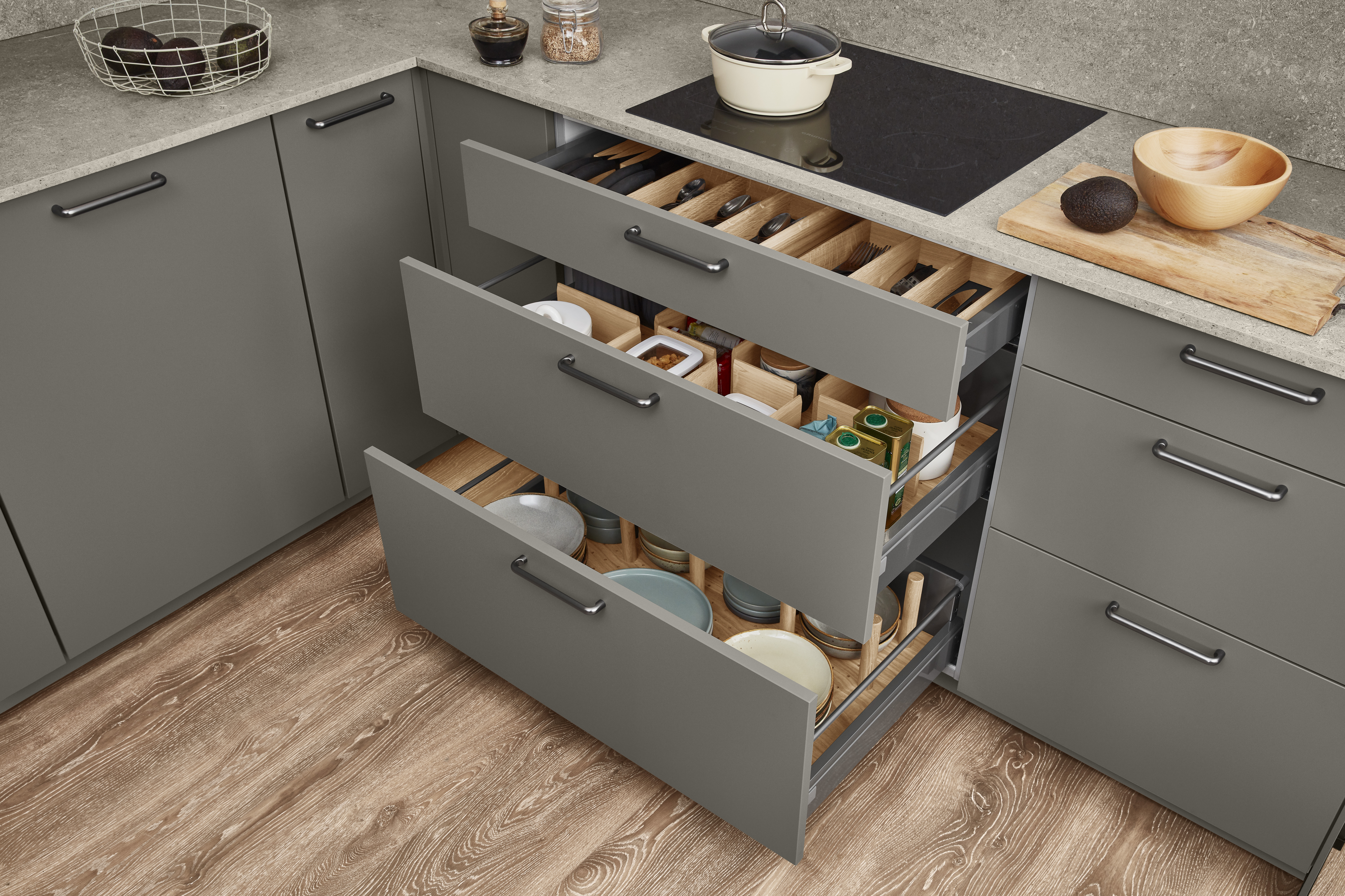 Organized base cabinet drawers that keep everyday cookware and utensils easy to access in a streamlined kitchen layout.