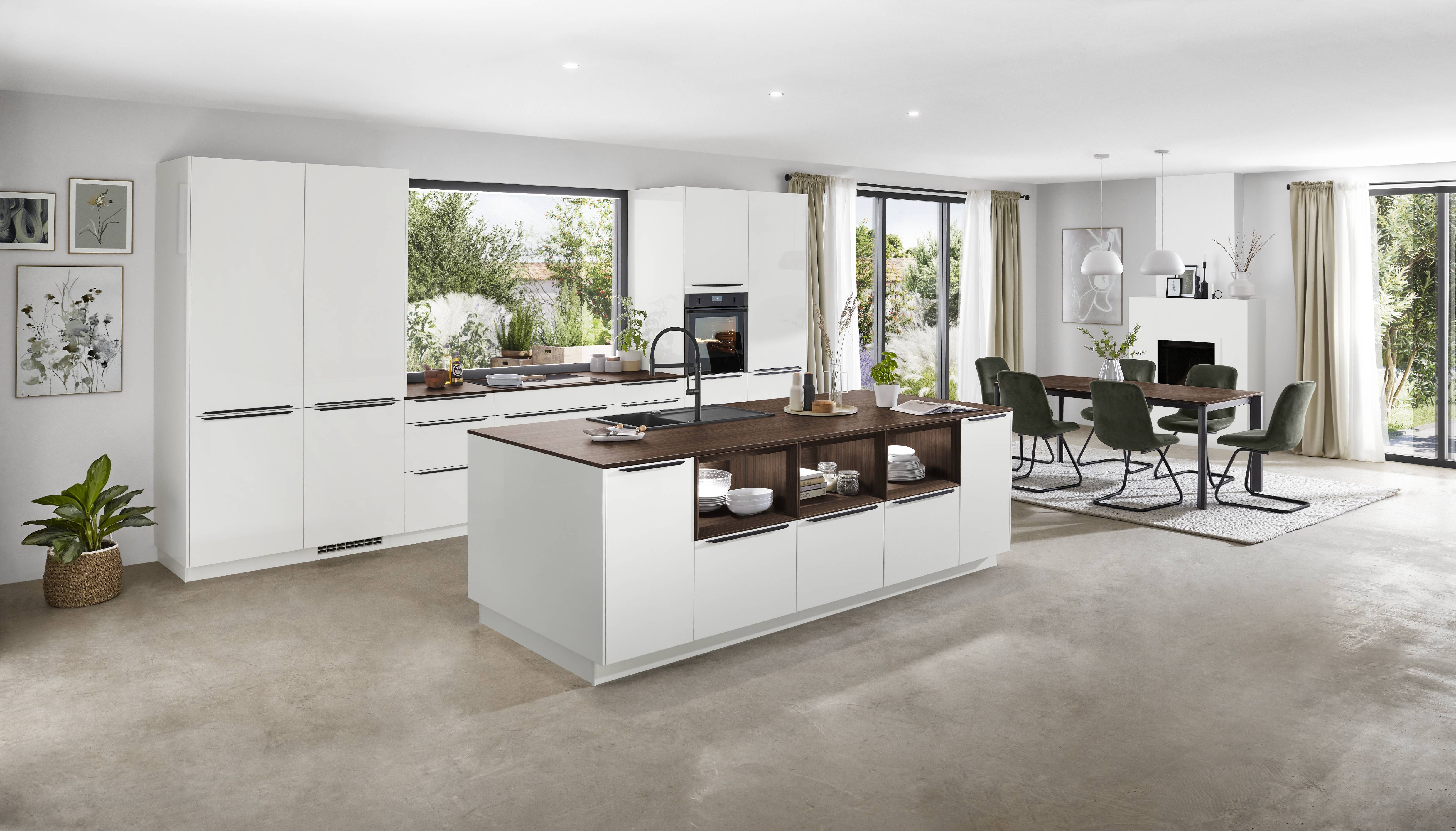 A bright Noblessa USA German kitchen featuring sleek white cabinetry, warm wood accents, an expansive island, and an open-concept dining area designed for effortless everyday living and entertaining.