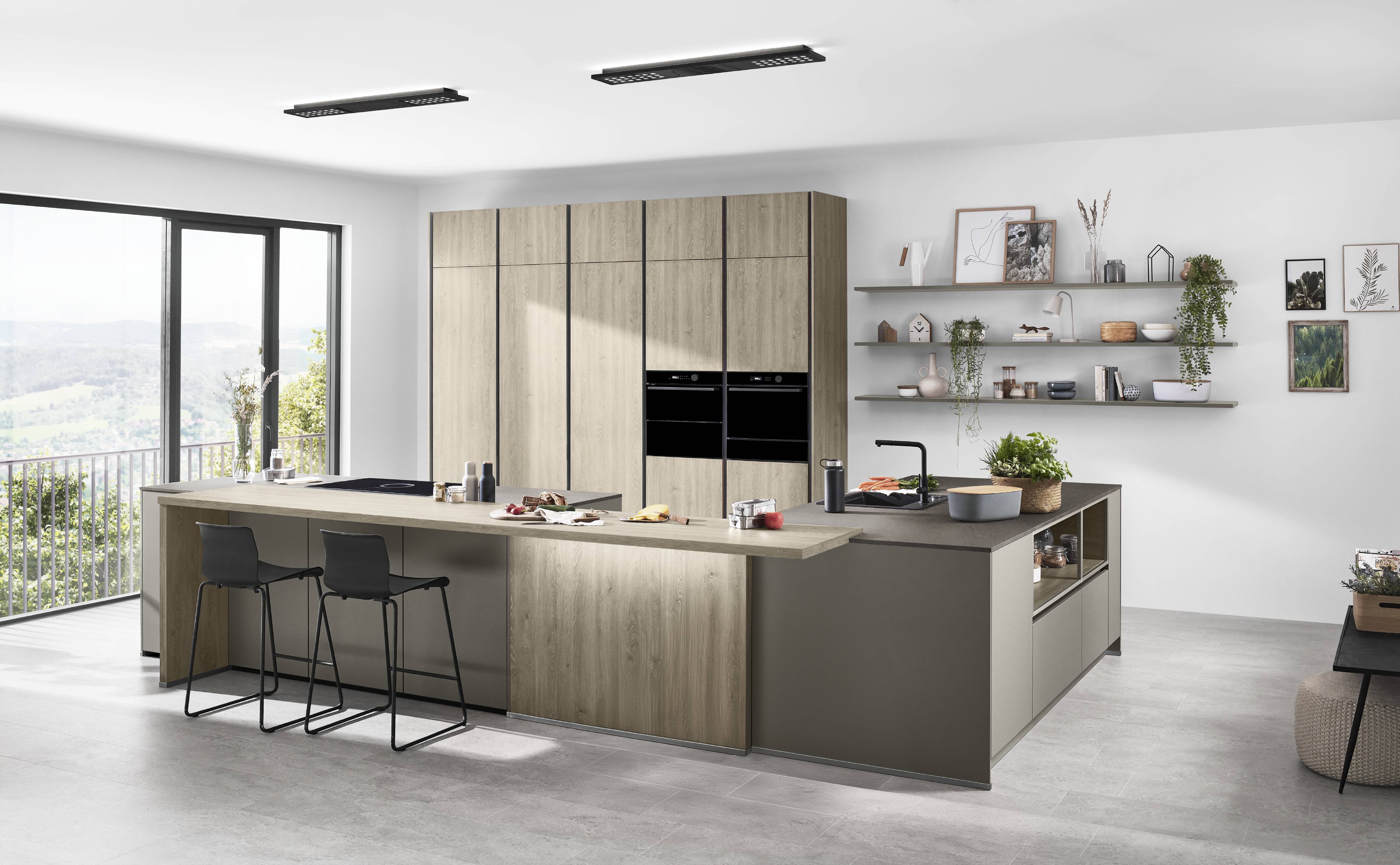 A bright, modern German kitchen with warm wood cabinetry, an extended island for seating, and open shelving for a relaxed, European look.