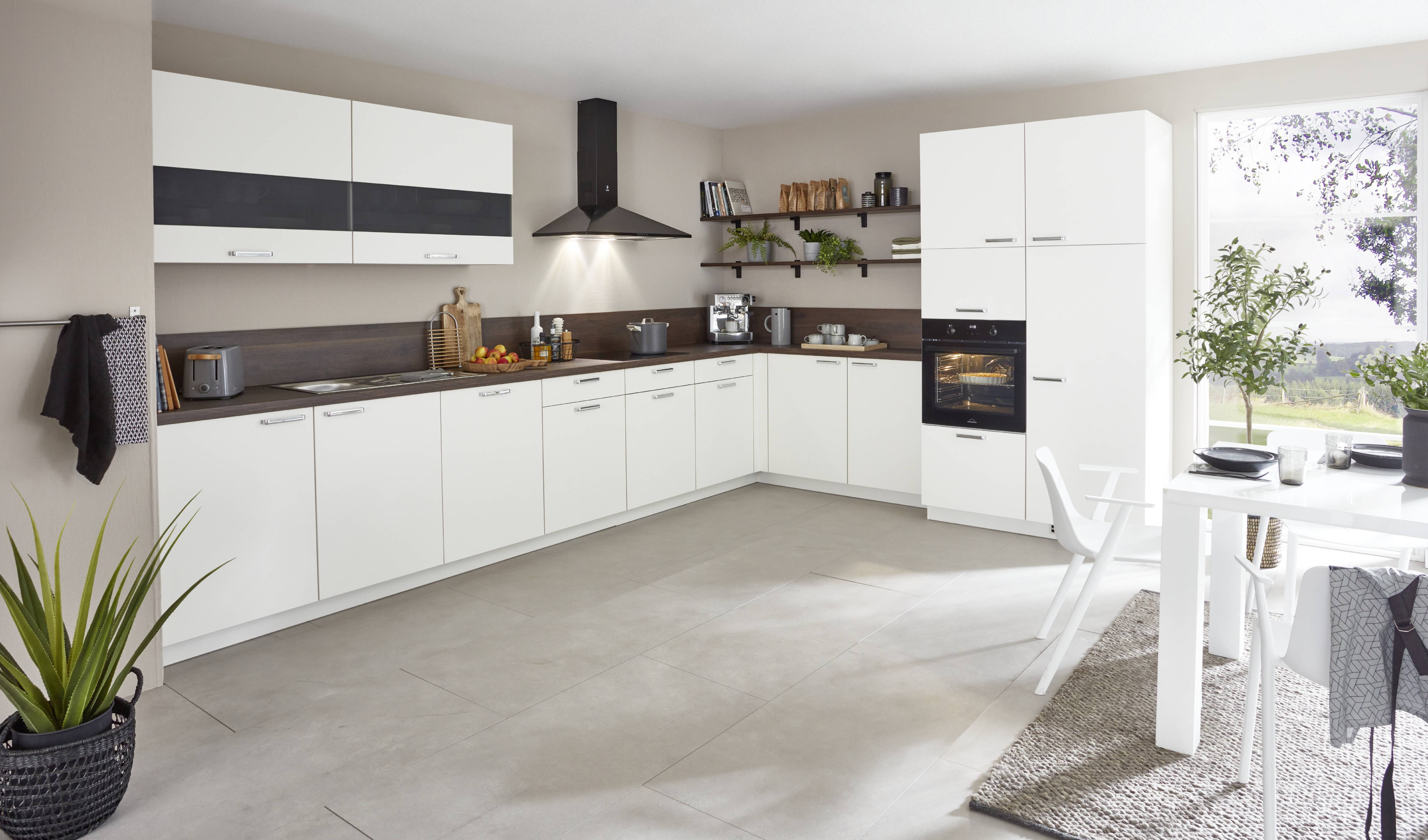 A bright and contemporary German kitchen by Noblessa USA featuring sleek white cabinetry, warm wood accents, and a thoughtfully designed layout for everyday functionality.