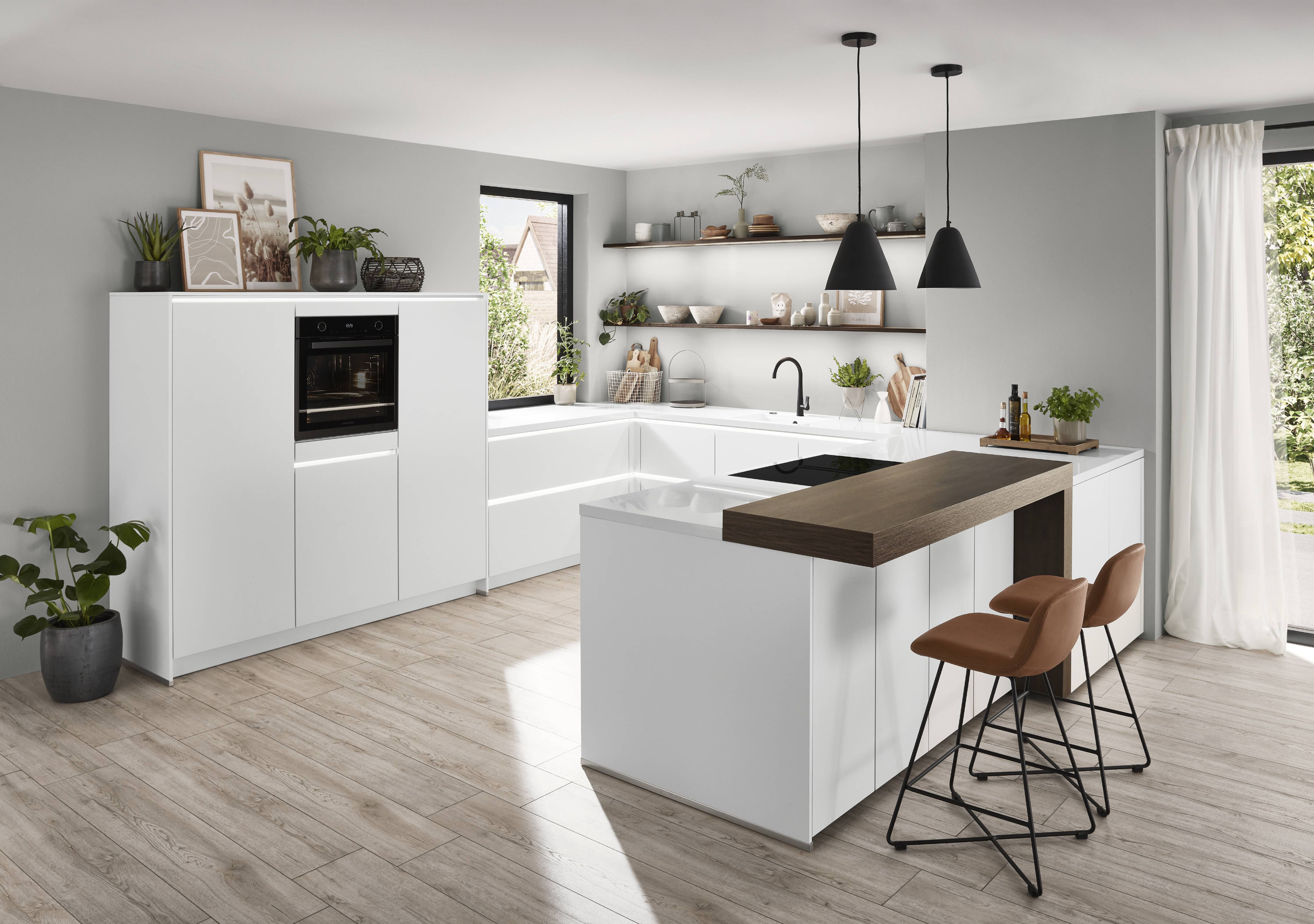 noblesa USA - Bright White German Kitchen with Warm Wood Island Bright modern German kitchen featuring white cabinetry, a wood-topped island with bar seating, open shelving, integrated appliances, and large windows.