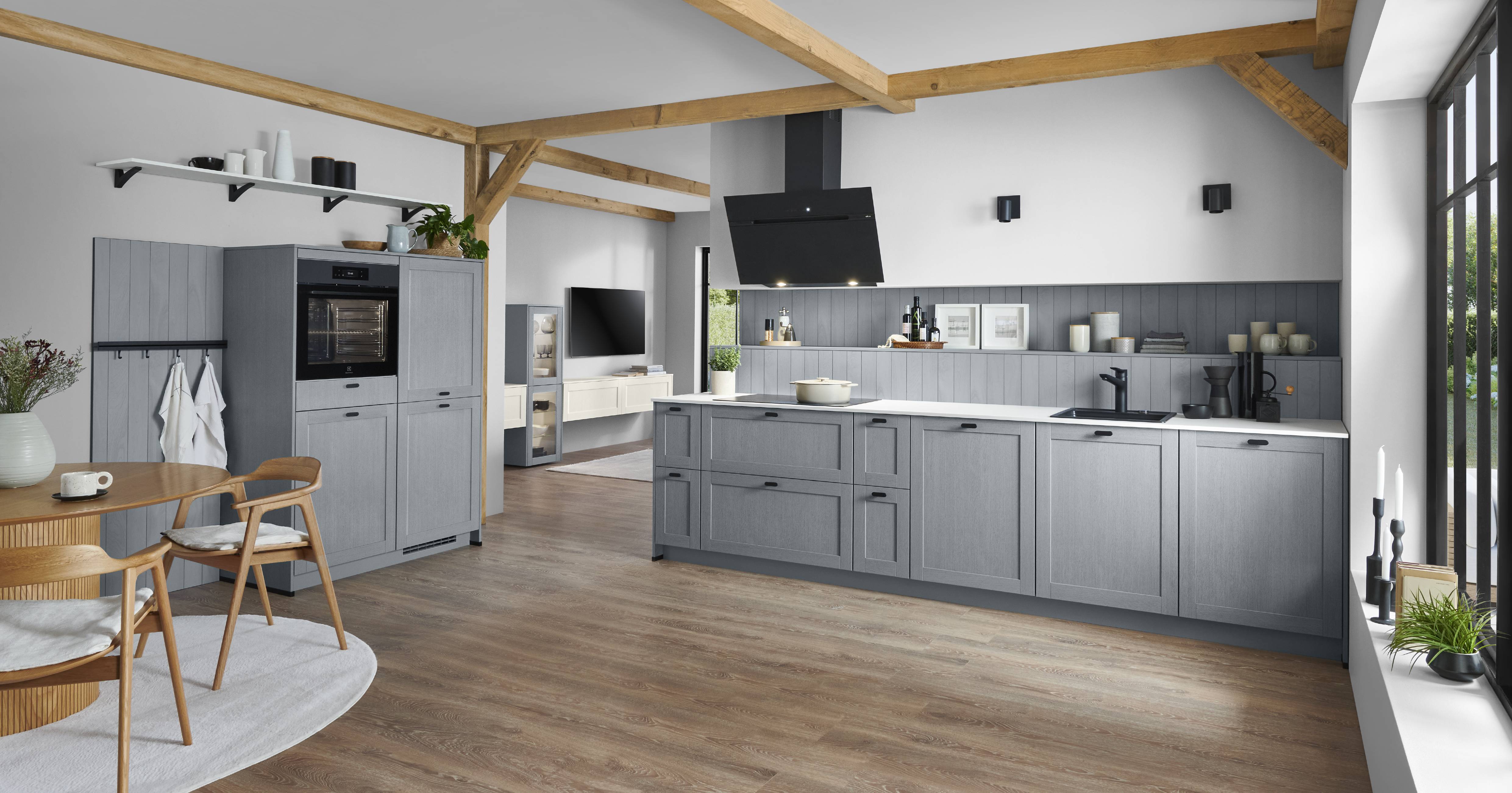 Noblessa USA - Modern Gray German Kitchen with Natural Wood Accents Modern German kitchen with gray cabinetry, a large island, integrated appliances, open shelving, natural wood beams, and large windows.