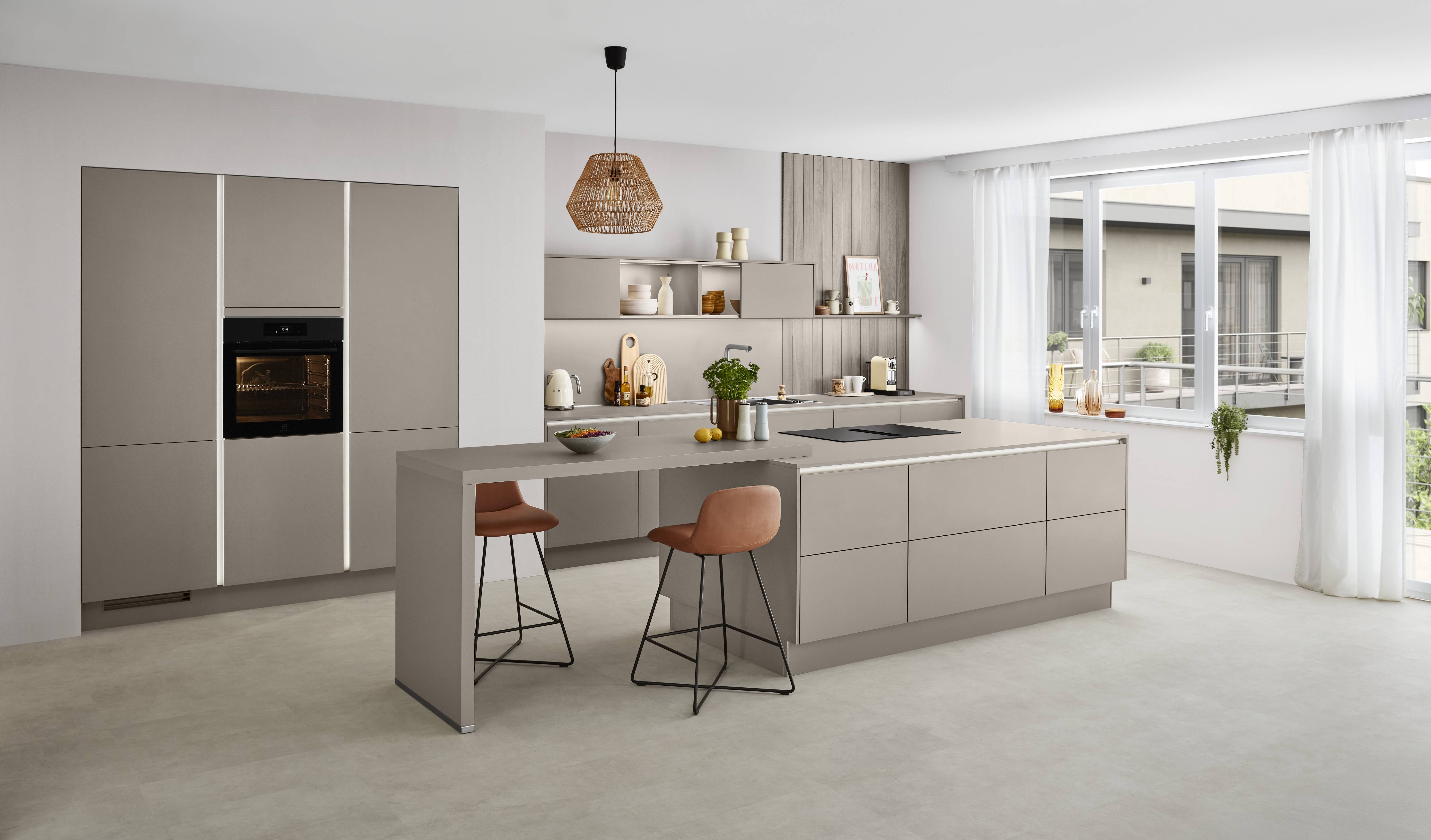 Noblessa USA - Modern German Kitchen with Matte Taupe Cabinetry and Contemporary Kitchen Island Modern German kitchen with matte taupe cabinetry, a spacious island with integrated seating, built-in appliances, open shelving, and large windows that fill the space with natural light.