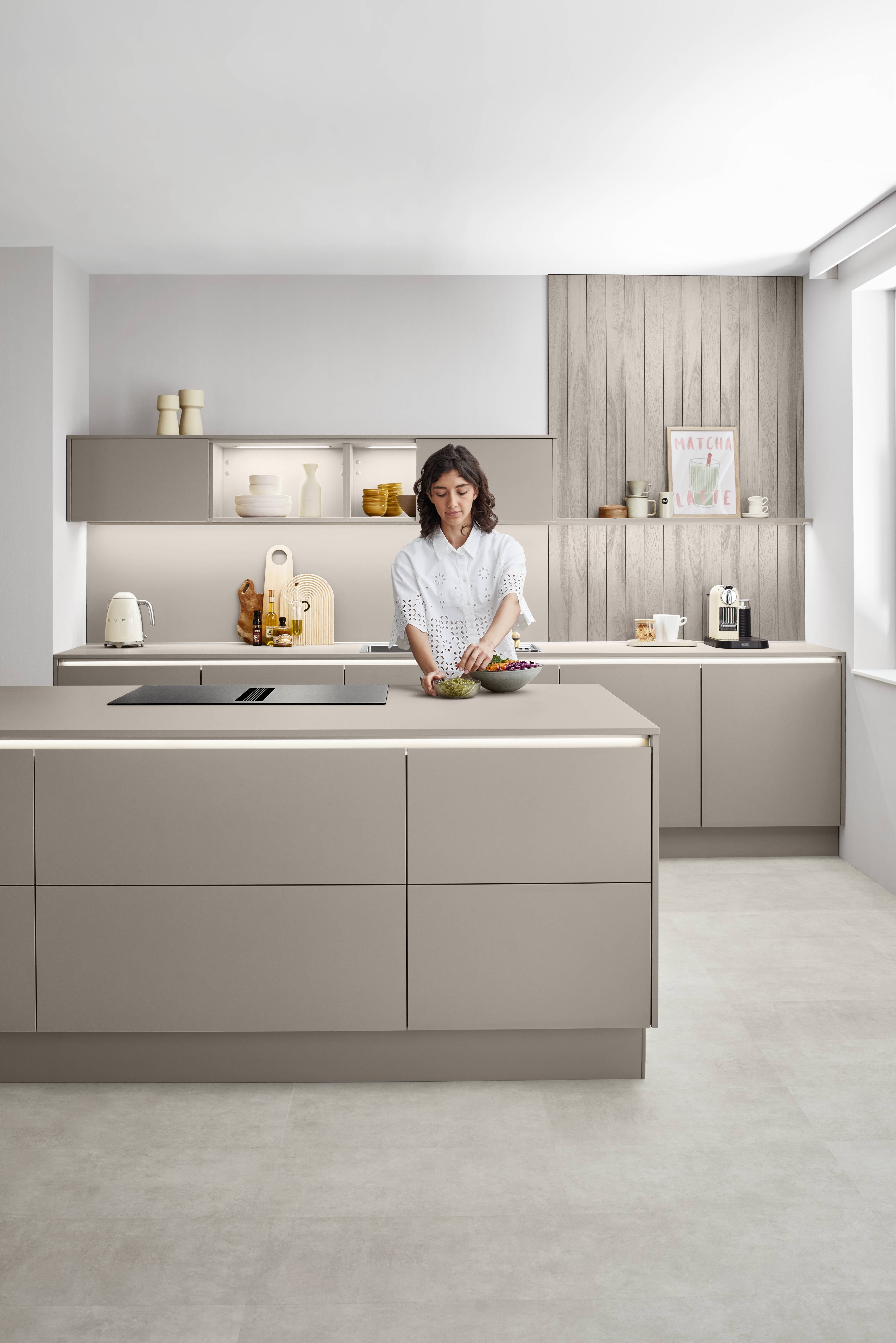 A handleless European kitchen design with integrated LED lighting and island