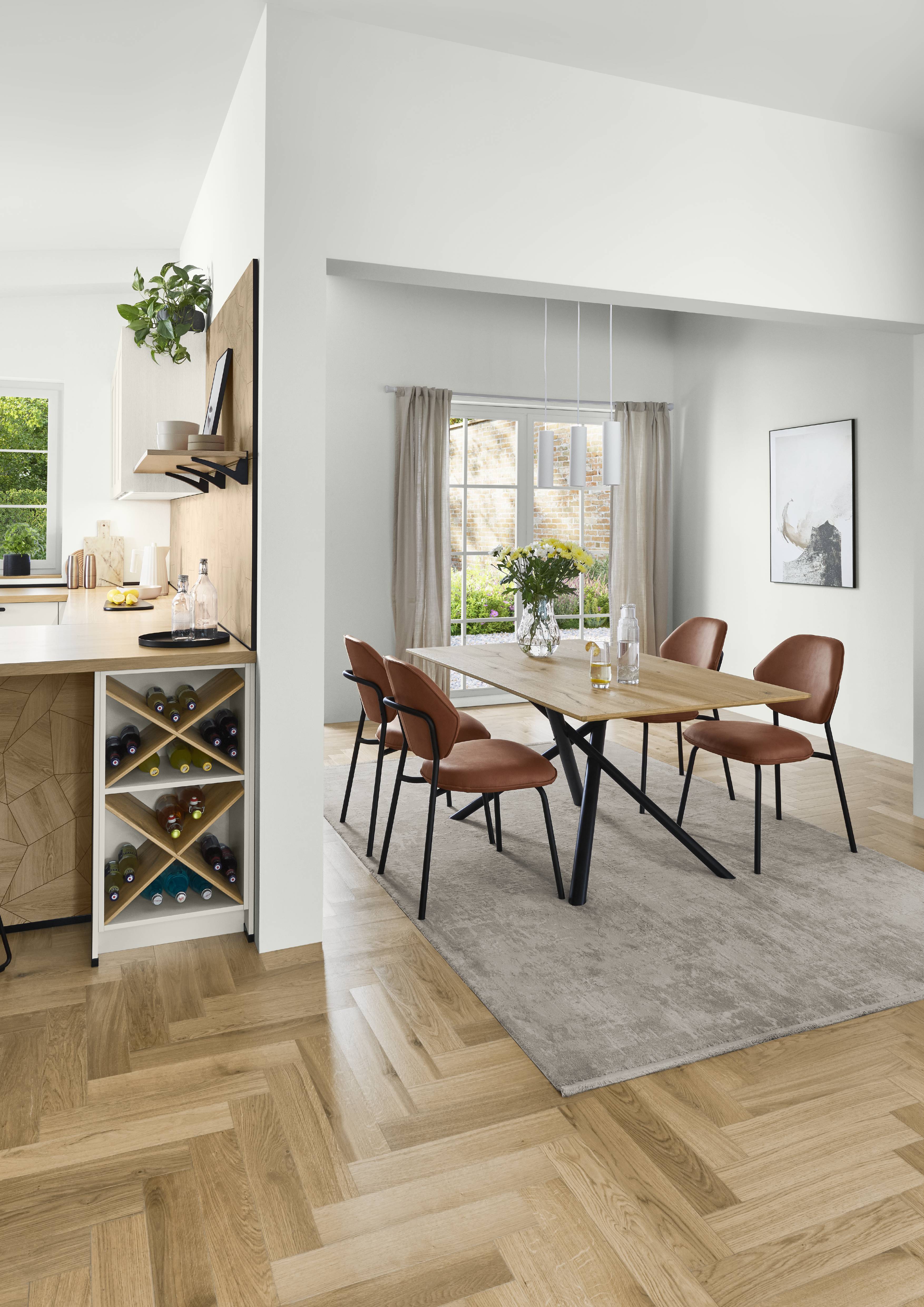 Bright dining and kitchen area with light wood flooring, minimalist finishes, and built-in storage for a clean, modern look