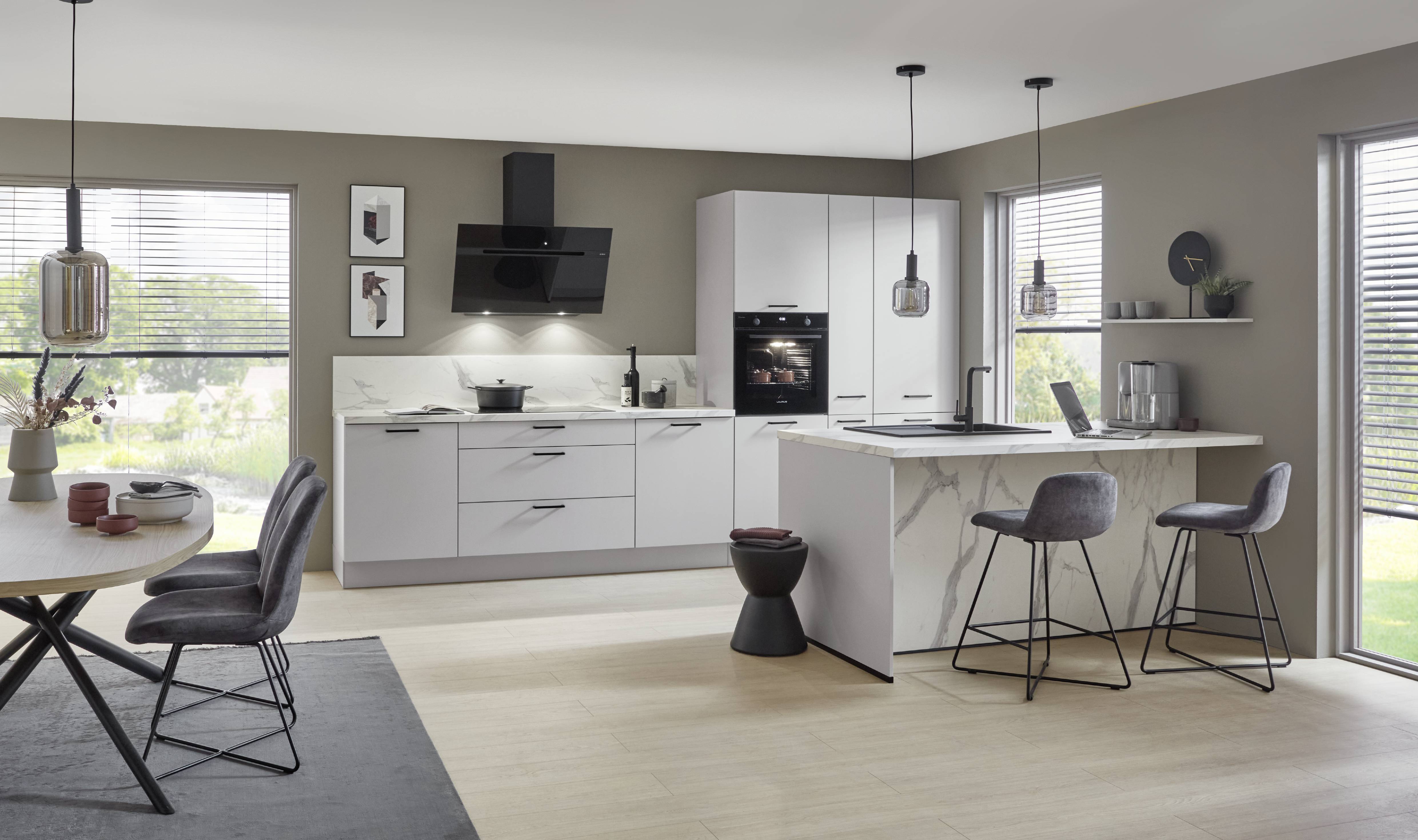 A modern German kitchen by Noblessa USA featuring sleek white cabinetry, a marble-look island, and a thoughtfully designed layout that blends everyday functionality with contemporary elegance.