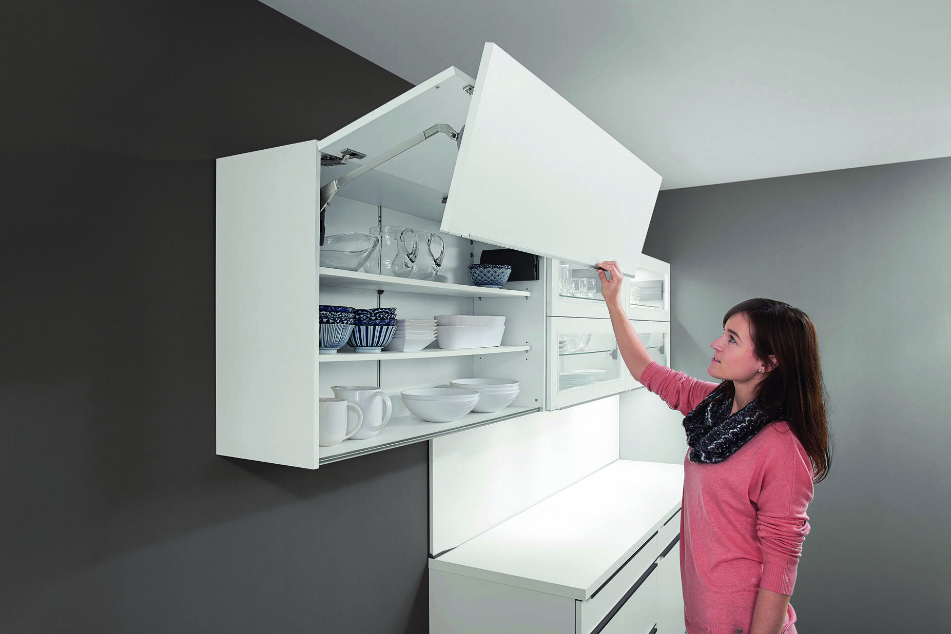 A modern European kitchen cabinet with a lift-up door system, showcasing the intelligent storage design found across our kitchen collections.