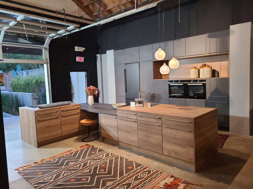 Pasadena kitchen showroom display featuring wood finishes and soft warm lighting.