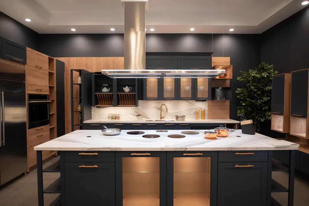 Cascada kitchen cabinet display in matte black with marble counter tops and wood reproduction detailing