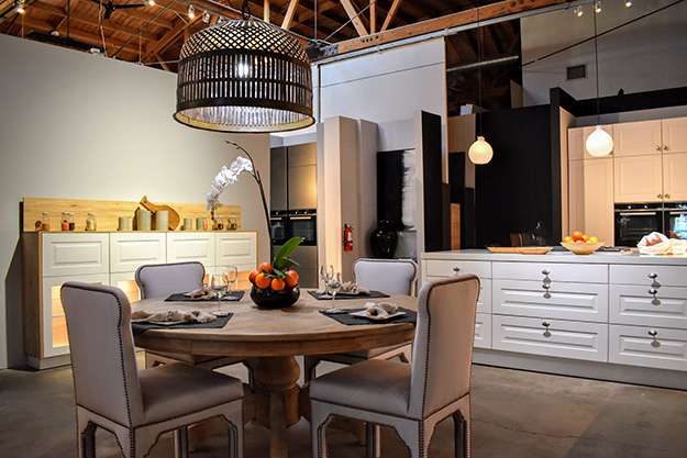 Pasadena kitchen showroom display. Image features a dining table display and soft warm lighting features.